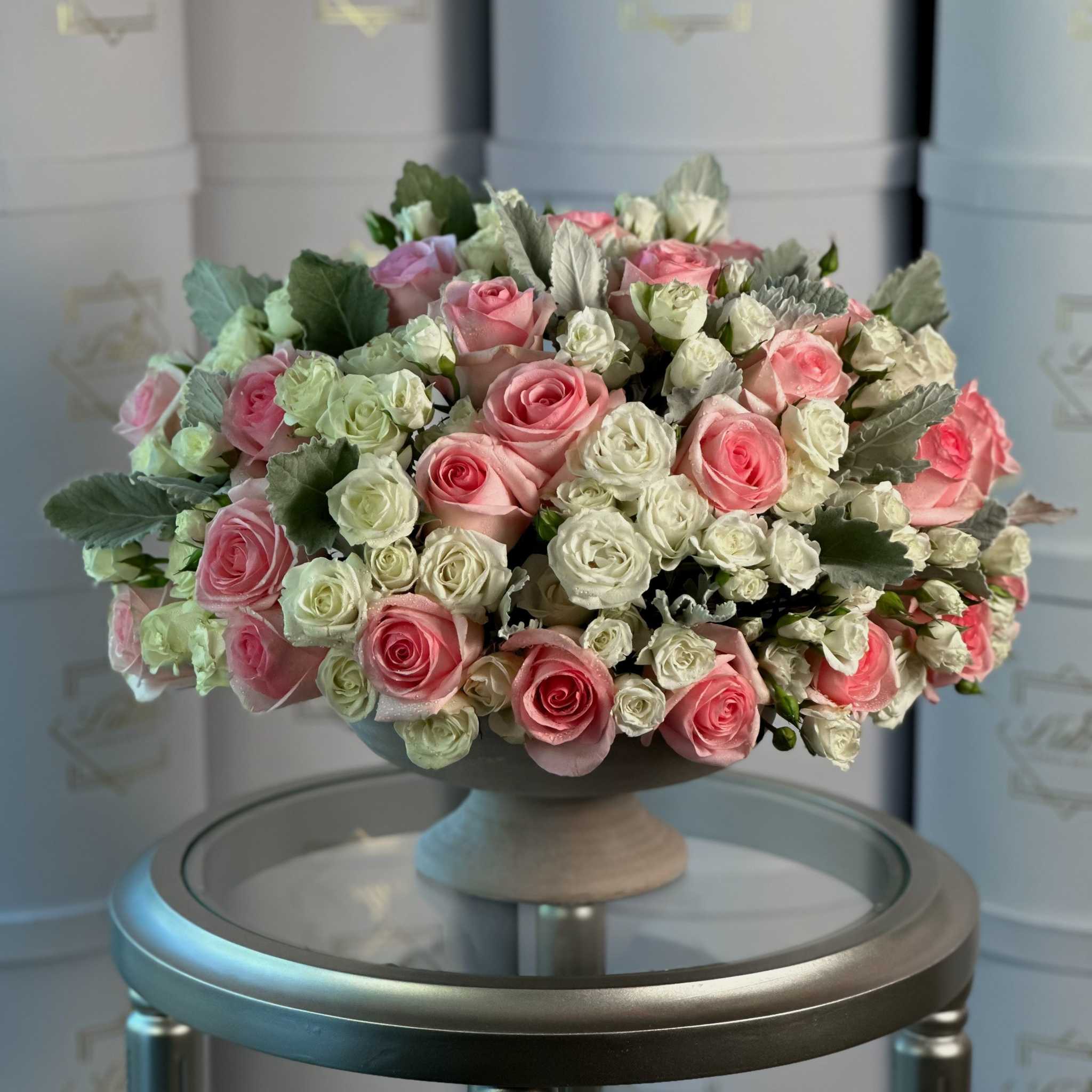 Gioia di Primavera floral arrangement with pink and white roses in pedestal vase