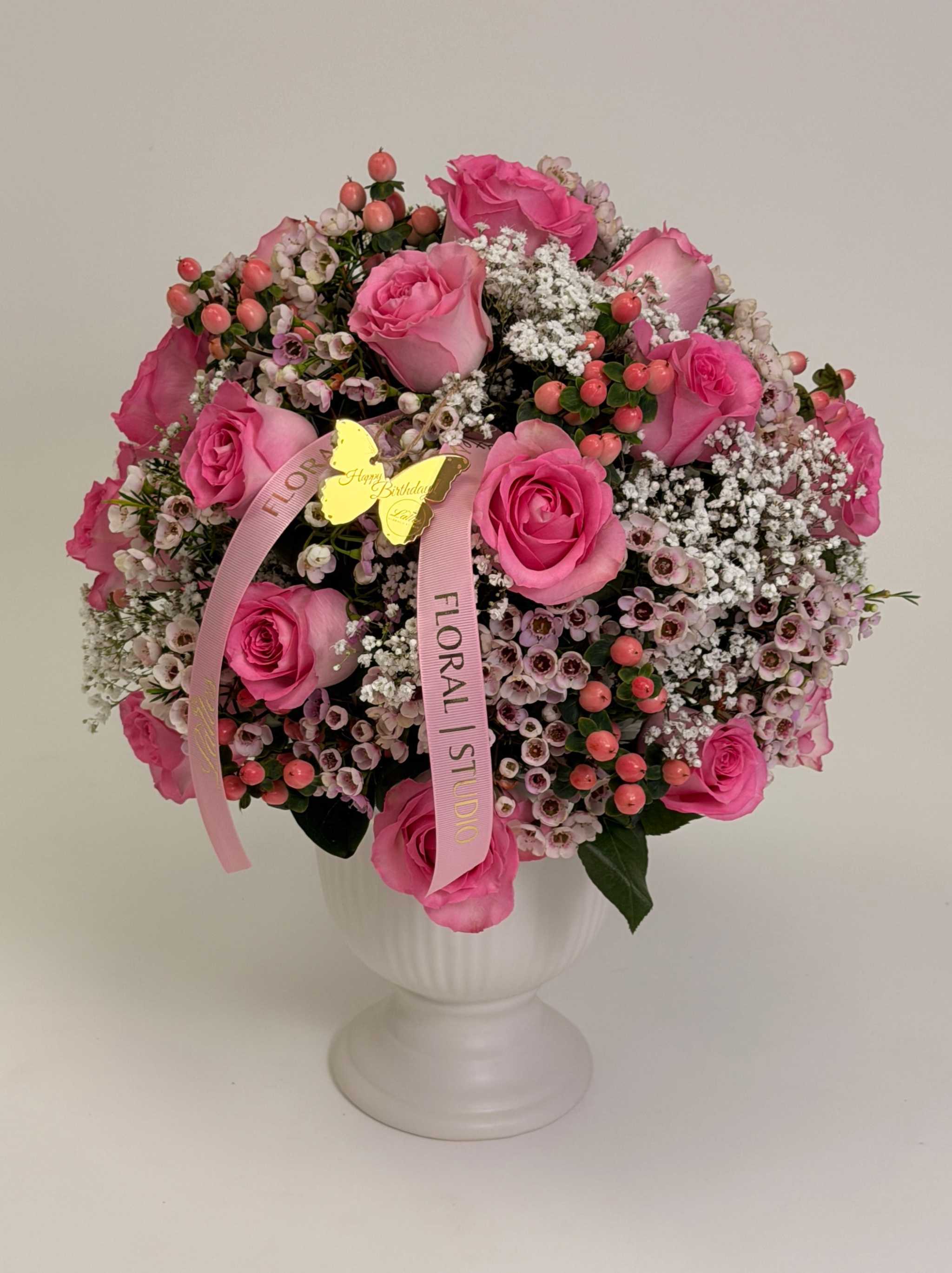 Blush Charm floral arrangement with pink roses and greenery in white vase