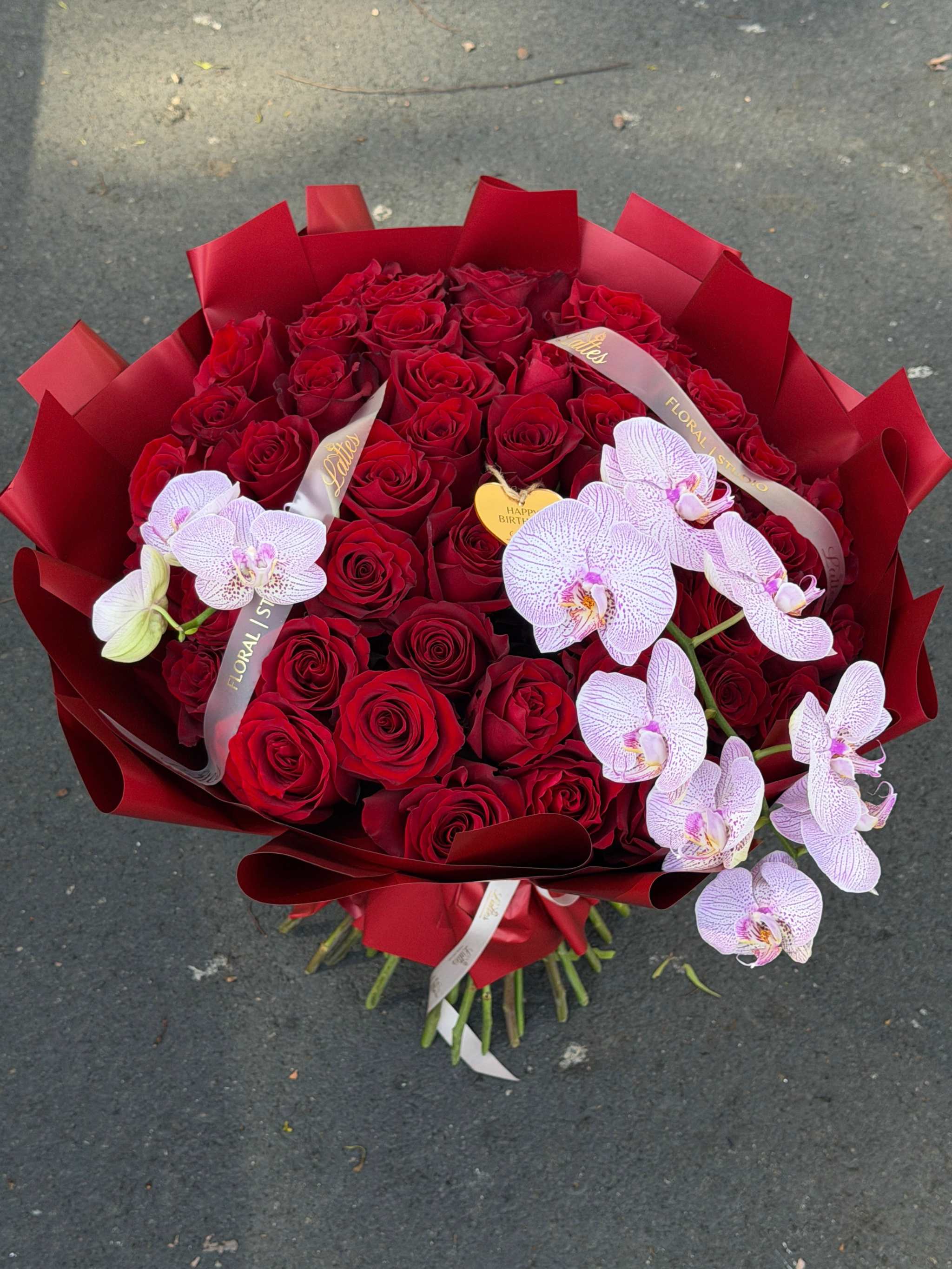 Luxurious bouquet of red roses and orchids for flower delivery orange