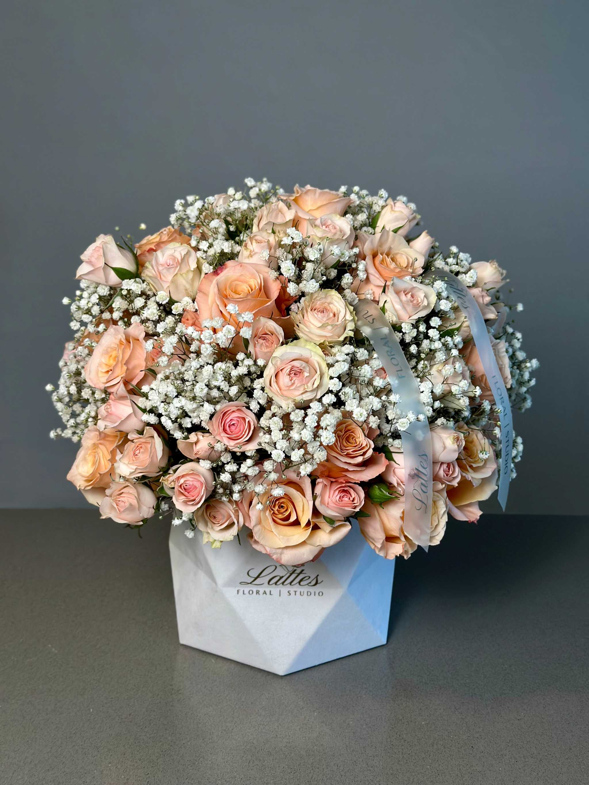 Elegance de Paris floral box with peach roses and baby’s breath in Lattes Floral Studio packaging