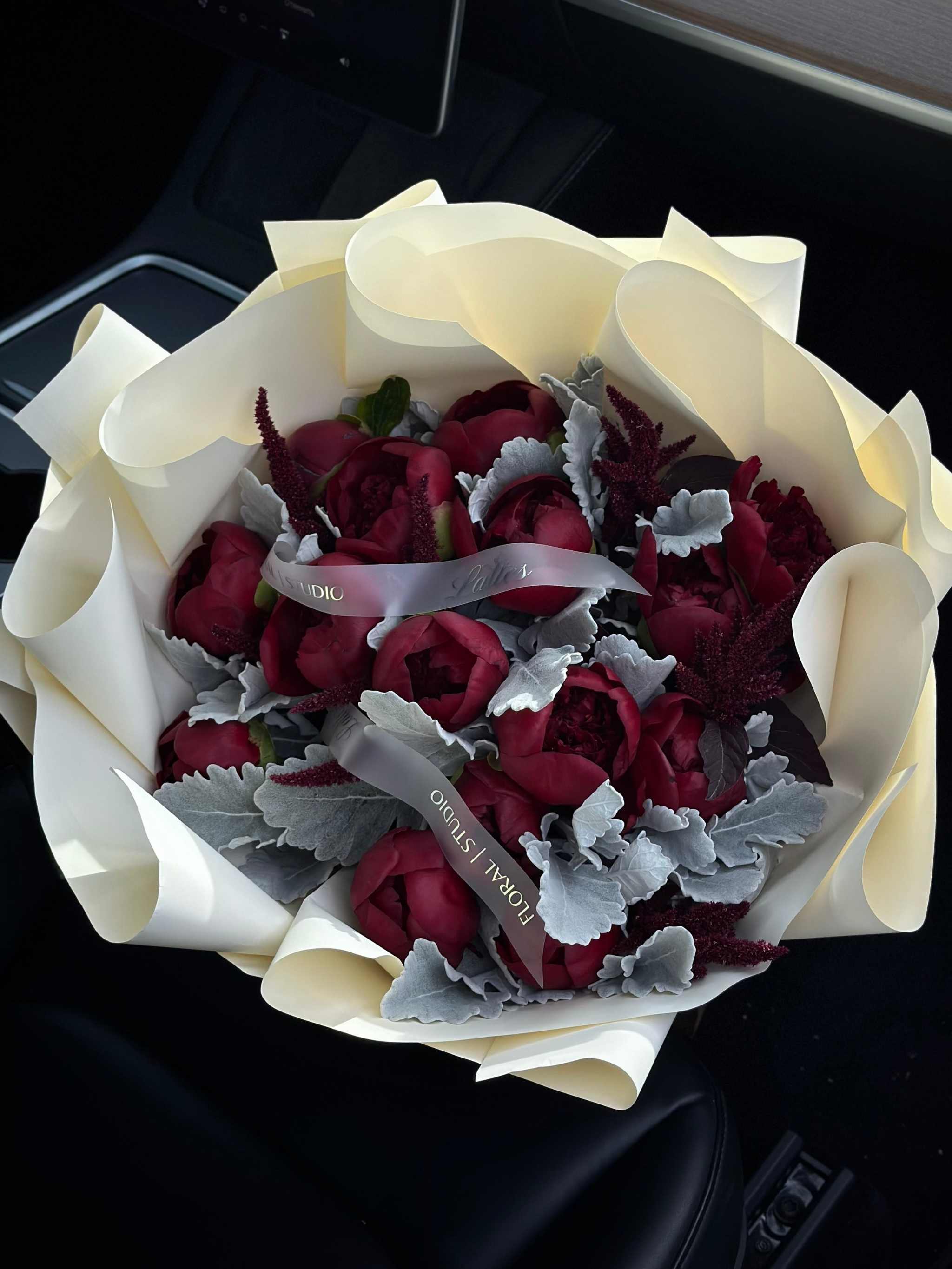 Velvet Passion bouquet with burgundy peonies and dusty miller wrapped in creamy paper