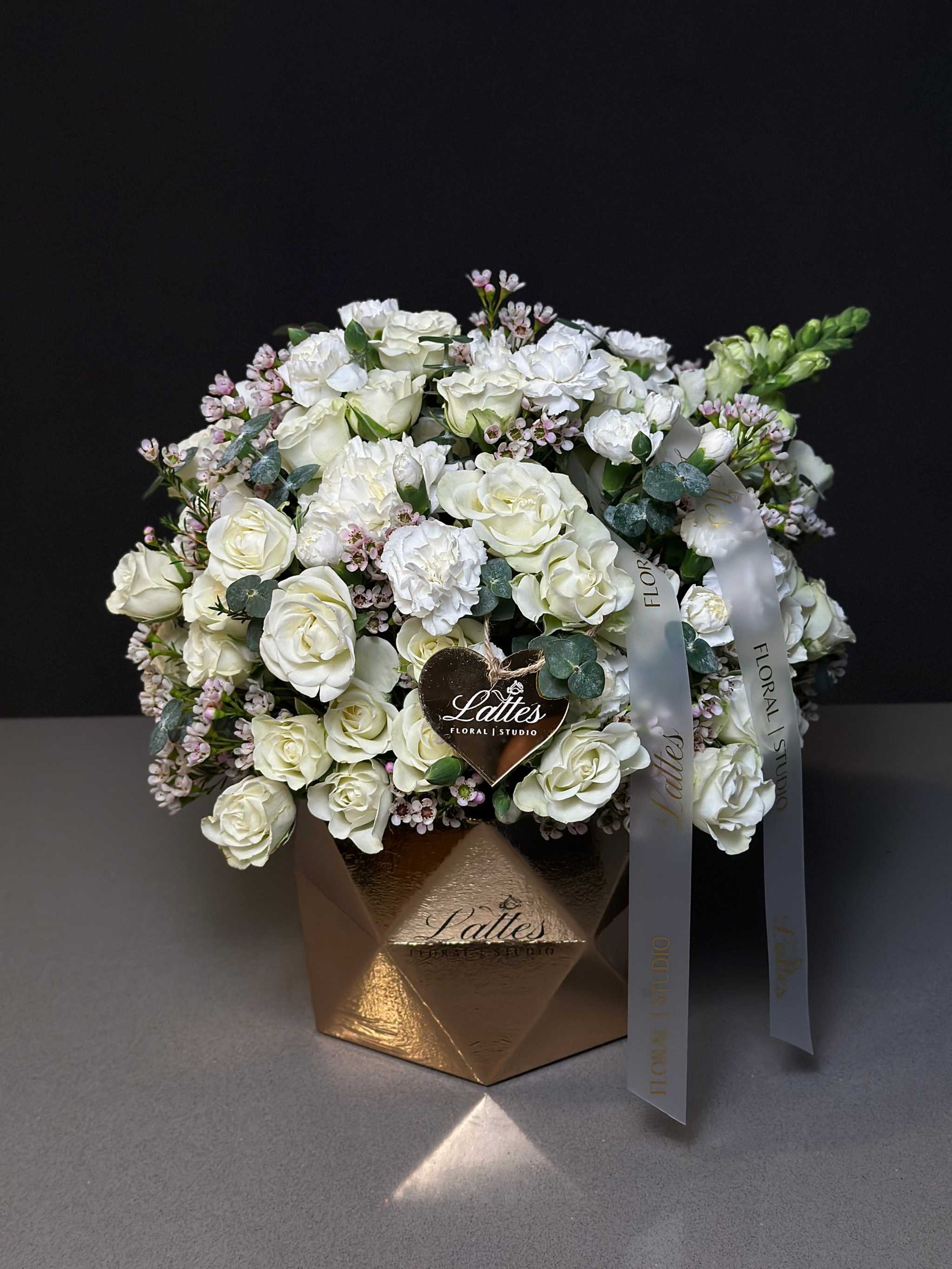 Golden Elegance Flower Box with white spray roses, carnations, lisianthus, and eucalyptus in gold geometric box