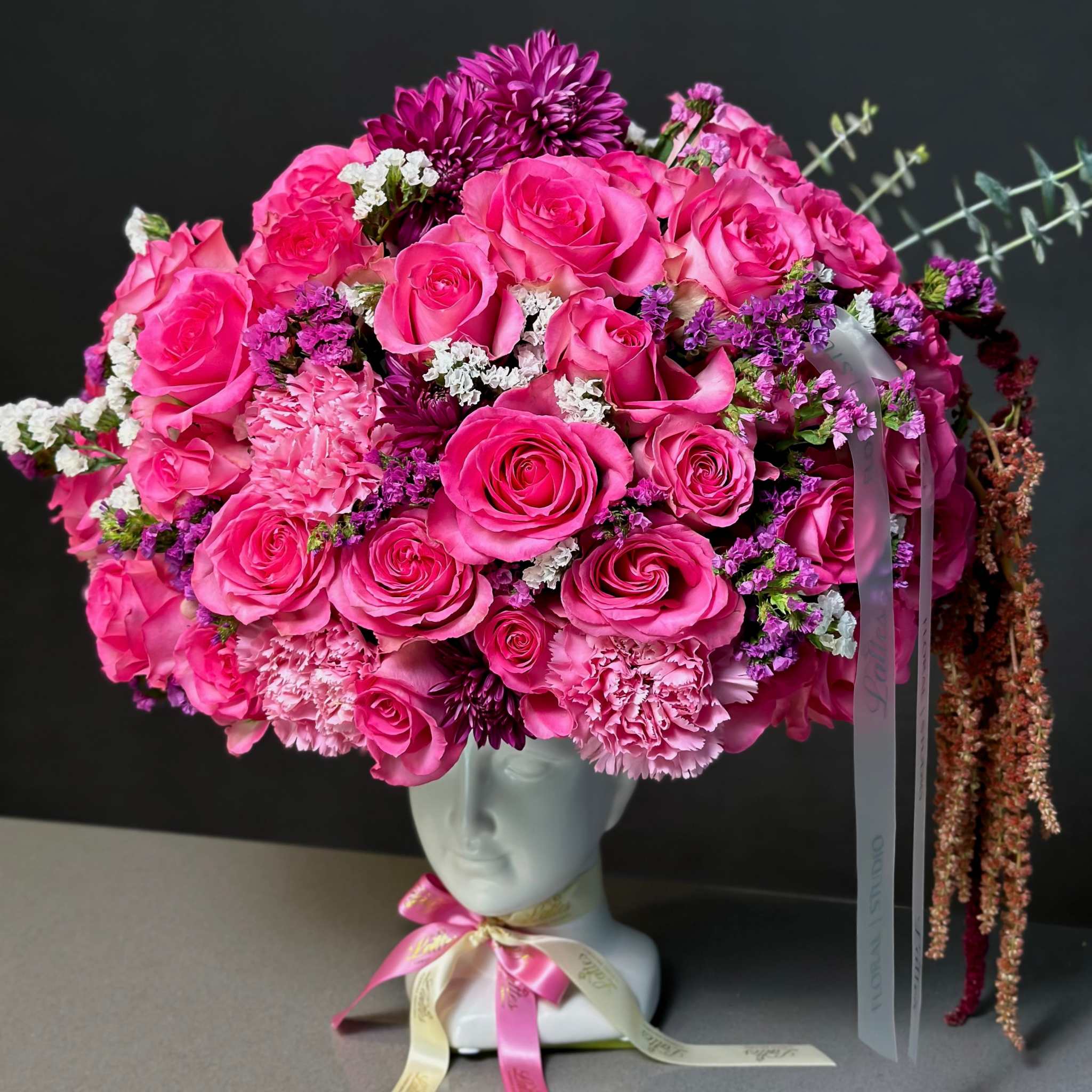 Jasmine arrangement with pink roses, carnations, chrysanthemums, and statice in an artful vase from Lattes Floral Studio