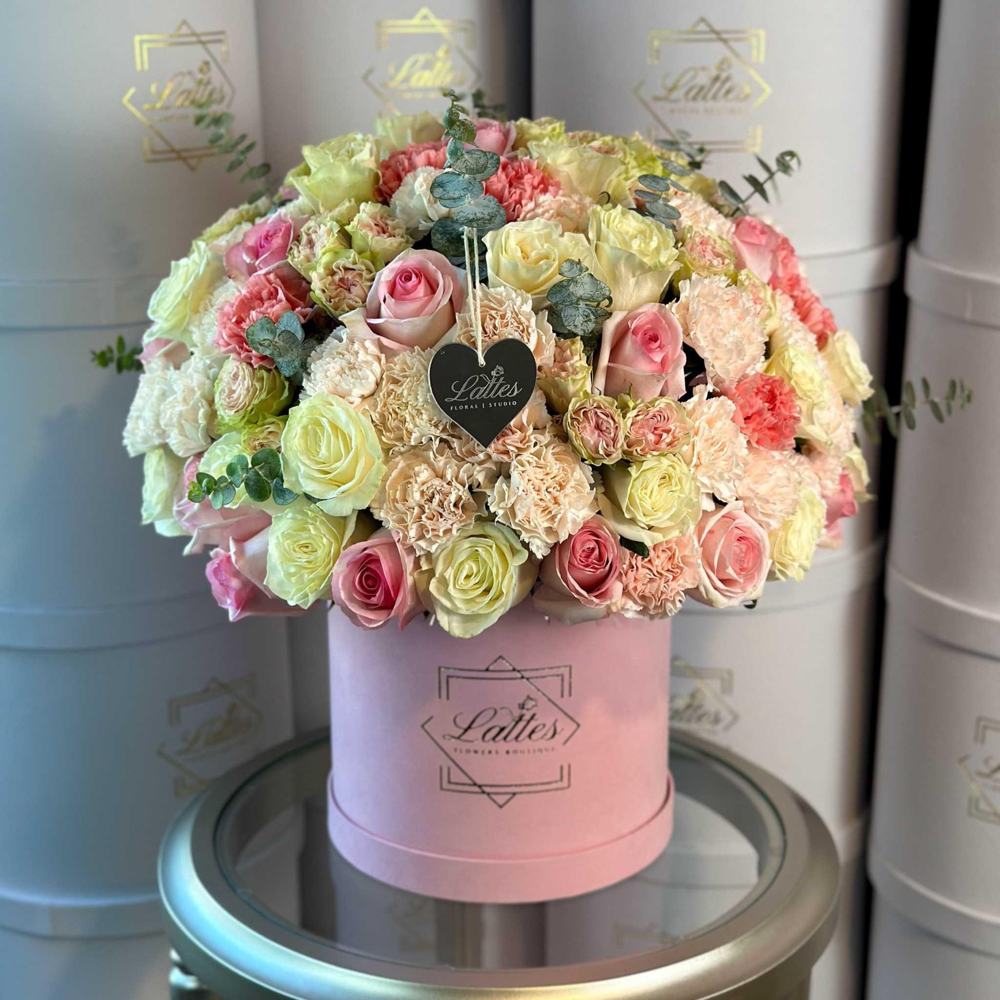 Fiore d’Amore pink and peach roses and carnations with green hydrangeas and eucalyptus in pink velour box