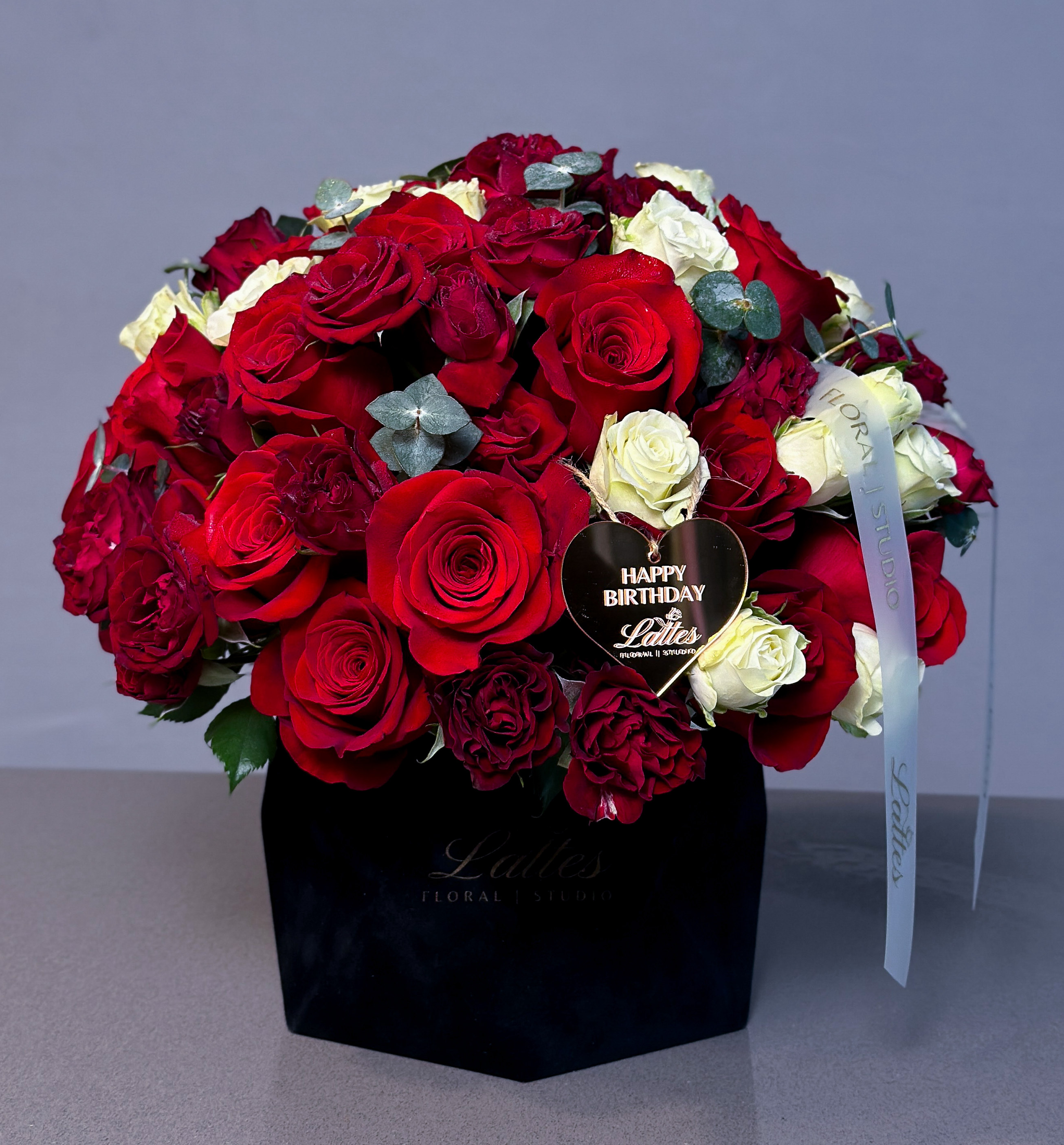 Passion & Elegance Flower Box with red roses, white spray roses, and eucalyptus in a black velvet box
