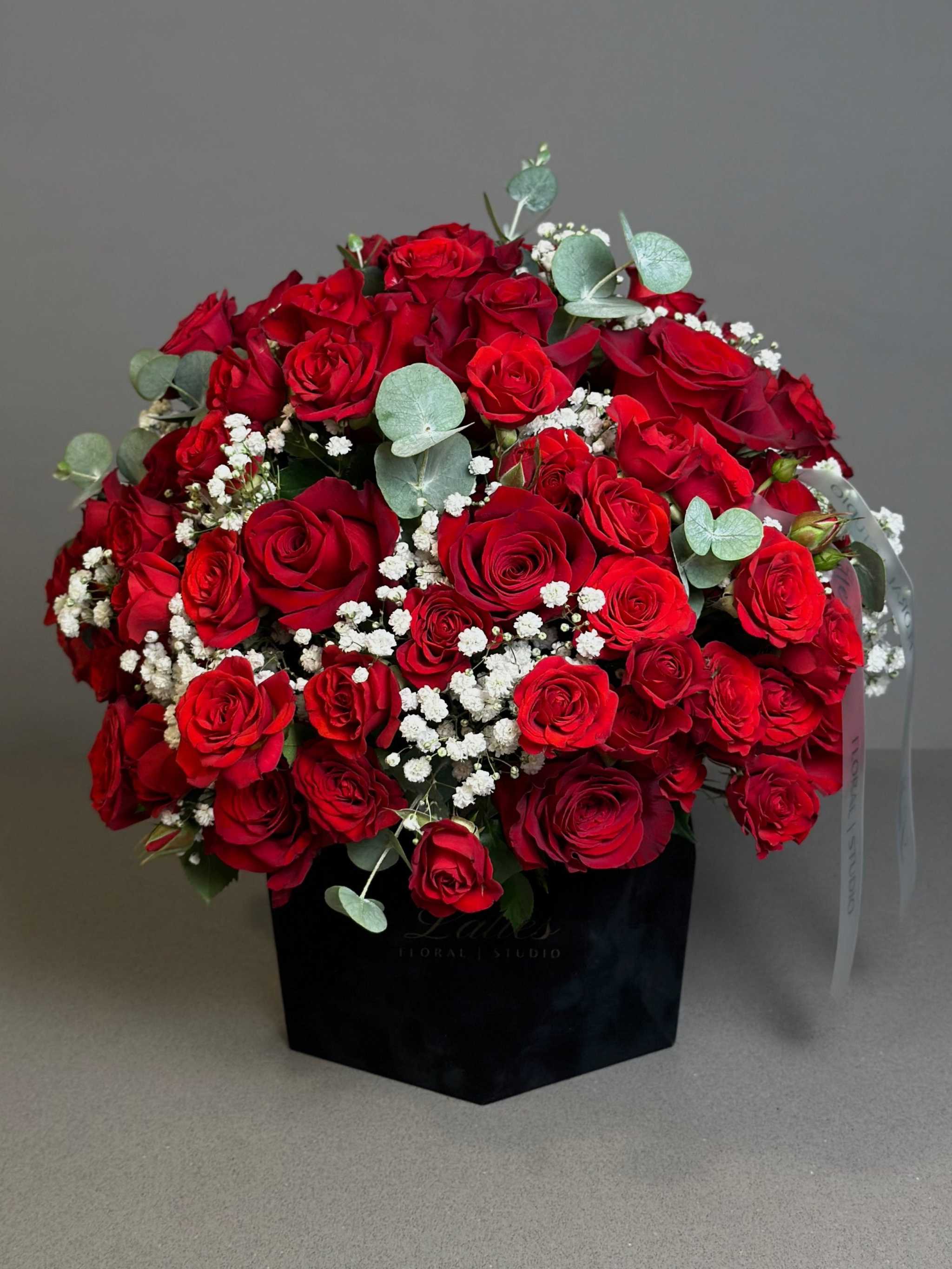Scarlet Symphony red and spray roses arrangement with baby's breath and eucalyptus in black velvet box by Lattes Floral Studio