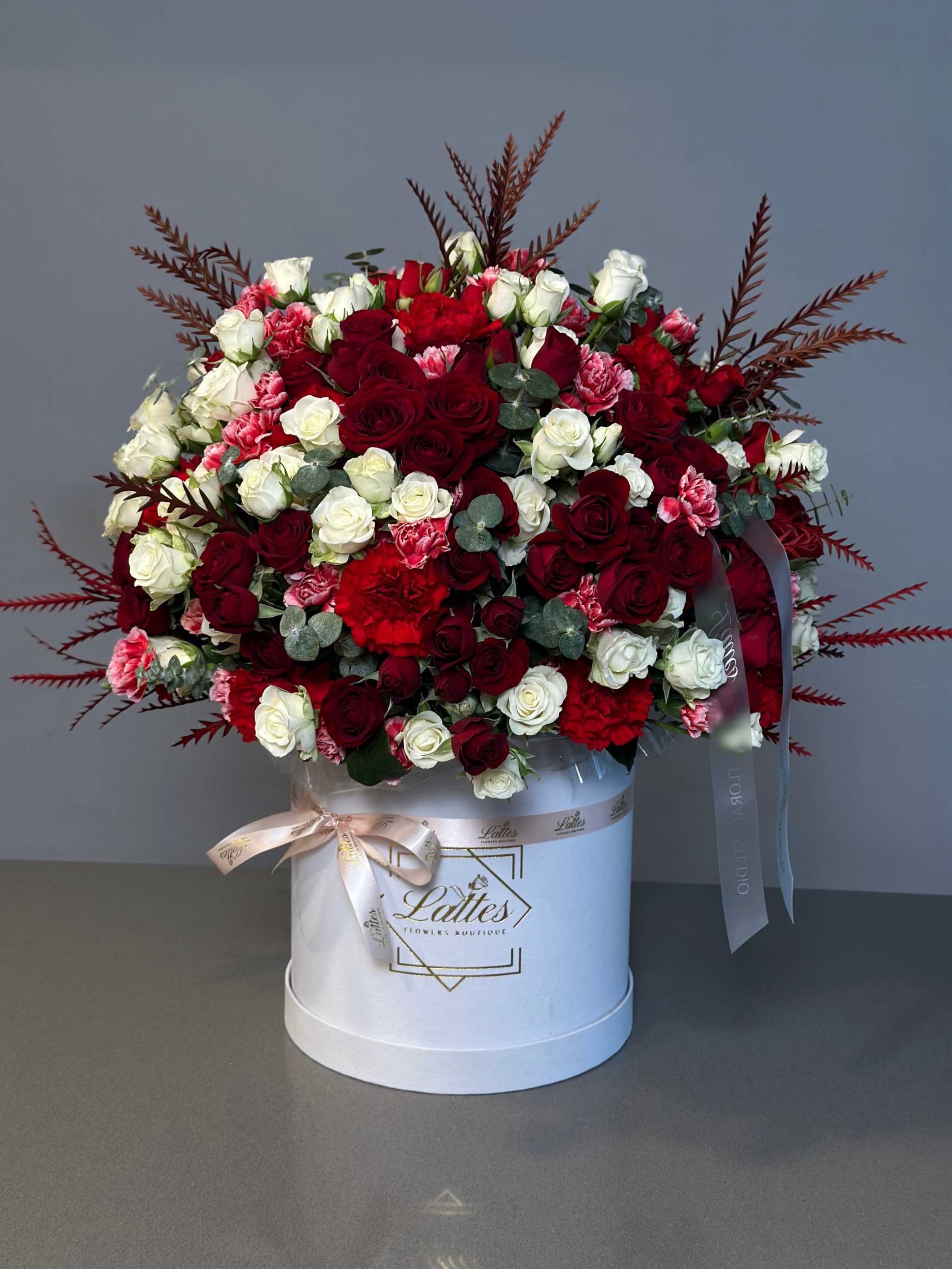 Crimson Elegance red and white roses bouquet in white box with carnations and eucalyptus