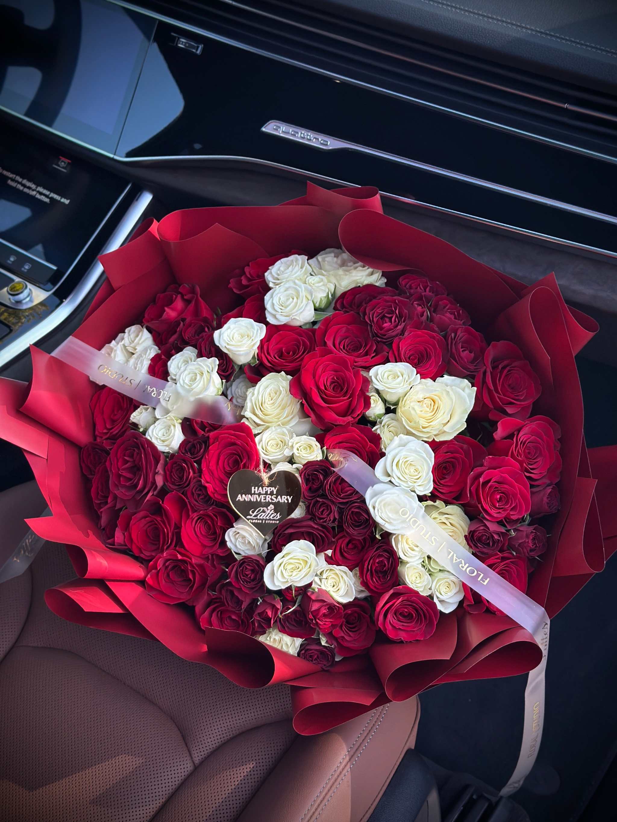 Amore Rosso bouquet with red and white roses in crimson wrapping by Lattes Floral Studio