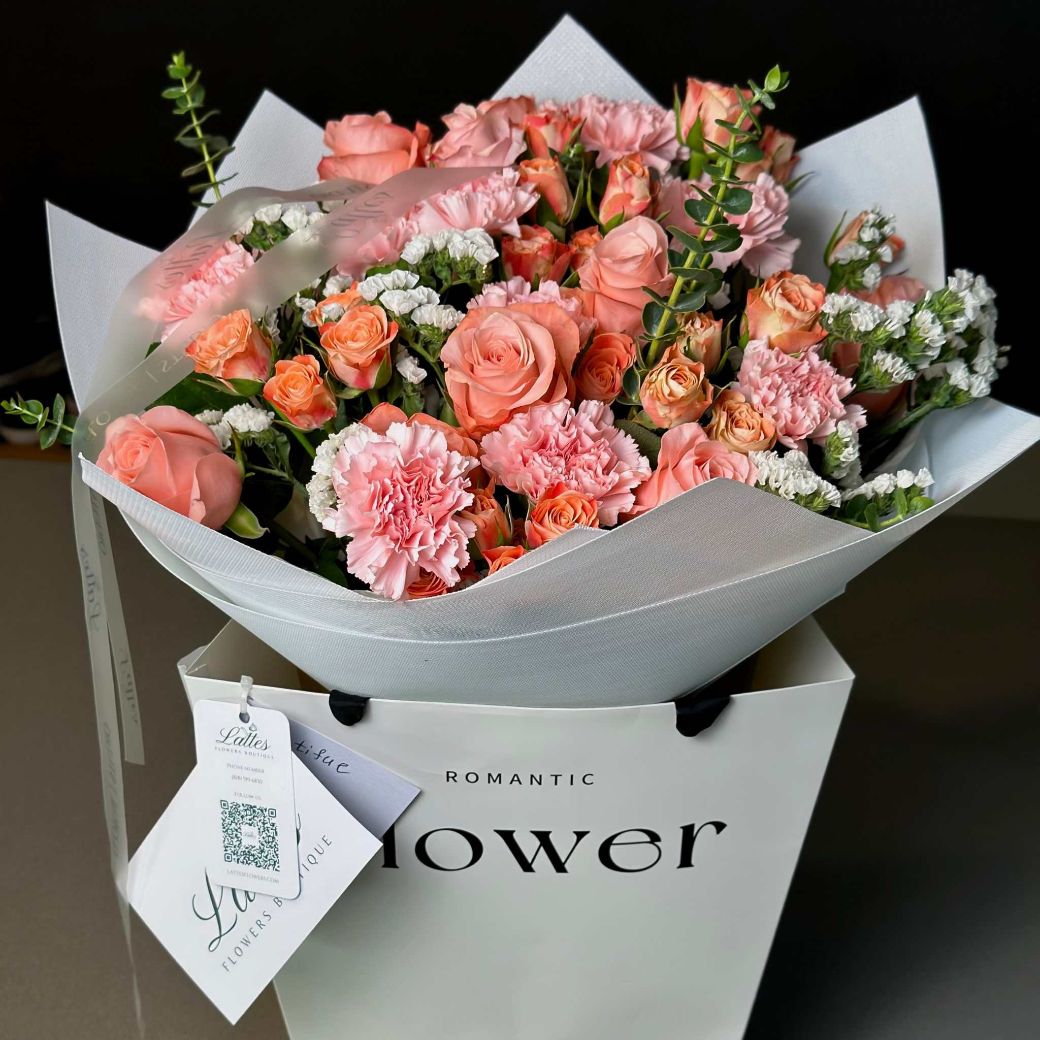 Peach and pink Love Peach Bouquet with roses, carnations, and eucalyptus flowers in a vibrant arrangement