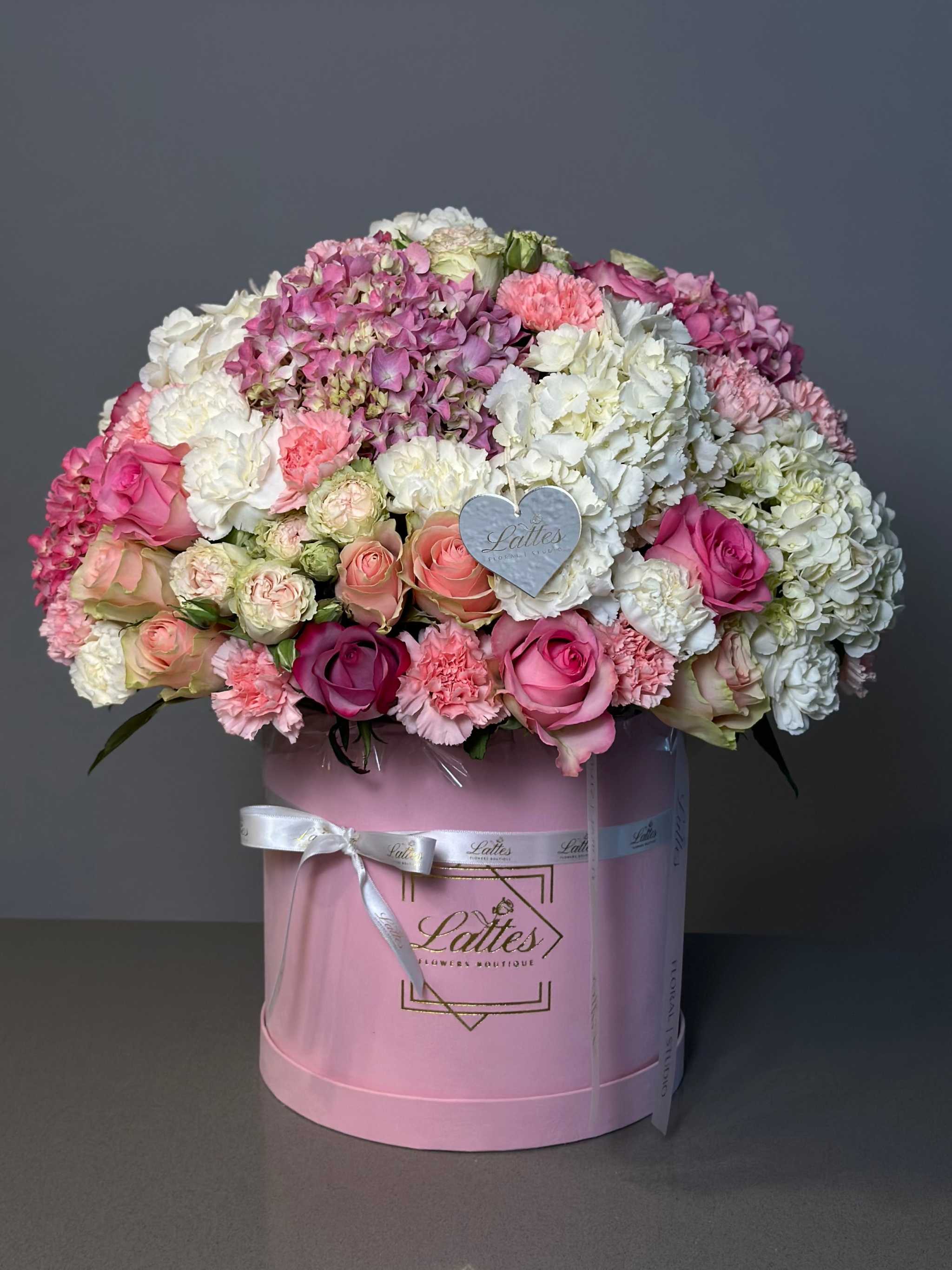 Floral Symphony pink roses and carnations in elegant round box by Lattes Floral Studio