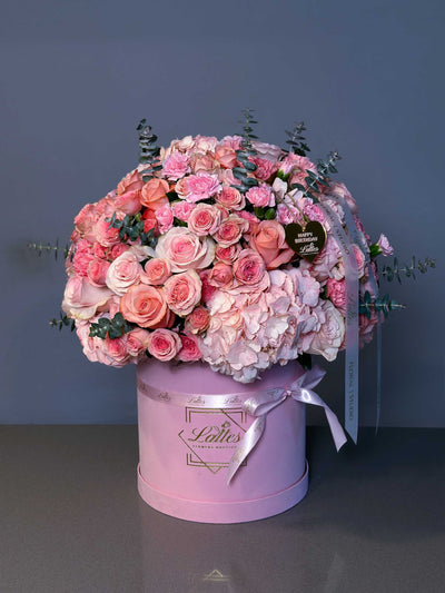 Blush Harmony Flower Box with pink hydrangeas, spray roses, and eucalyptus in a pink box