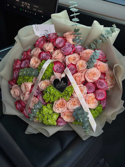 Jardin des Reves bouquet with green hydrangea, eucalyptus, pale pink and purple roses, elegant floral arrangement