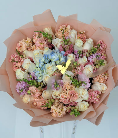 Butterfly Whispers – White Roses Blue Hydrangea & Peach Stock Bouquet