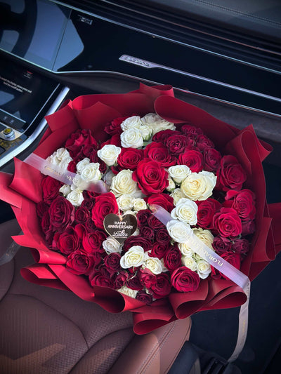 Amore Rosso bouquet with red and white roses in crimson wrapping by Lattes Floral Studio