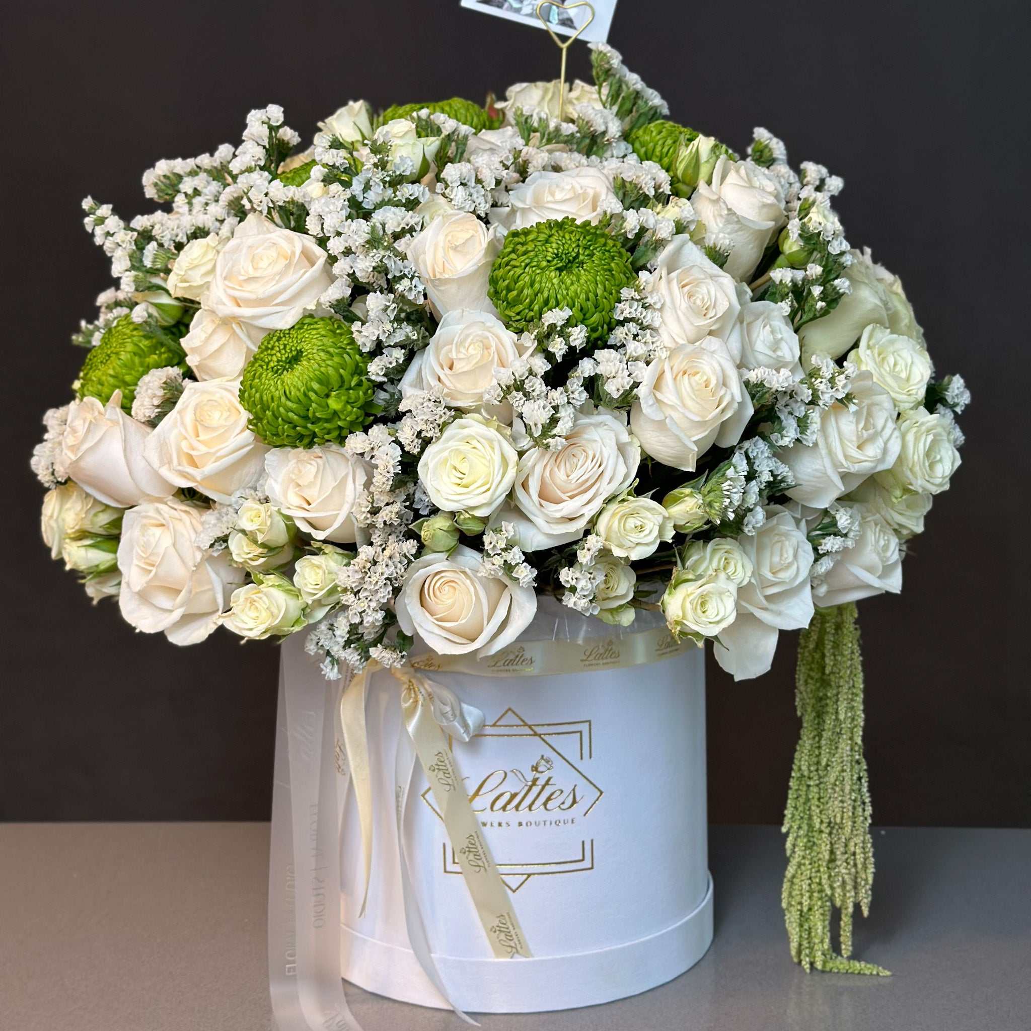 Serenity Flower Box with white roses and green accents in a white hatbox