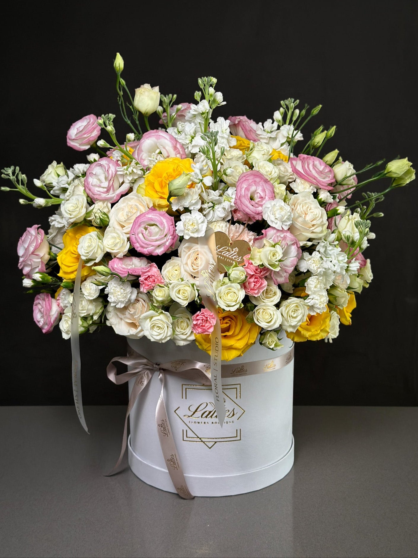 Bouquet of flowers in a white box with a black background