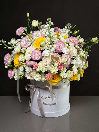 Pastel Garden flower box with pink lisianthus, mix roses, and white flowers in a pastel-themed arrangement
